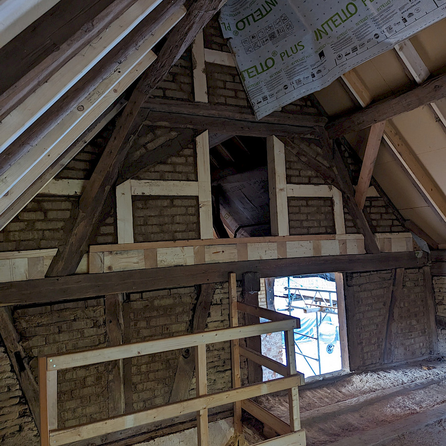 Neu augemauertes Fachwerk und Holzgeländer im Scheunenhaus